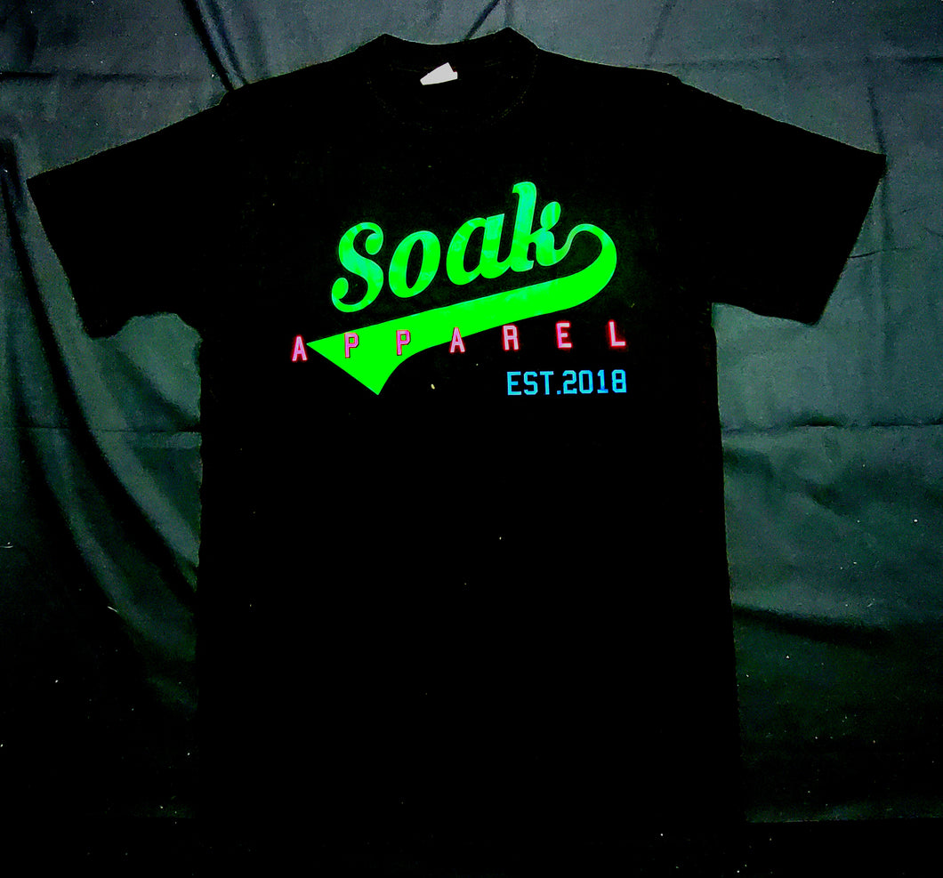 SOAK APPAREL SHIRT green soak with the pink apparel letters